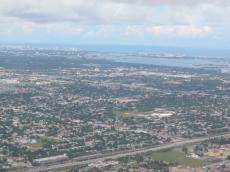 landscape from airplane aerial photo roads brown clouds city buildings