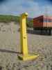 maartent yellow pole on beach with no clear purpose