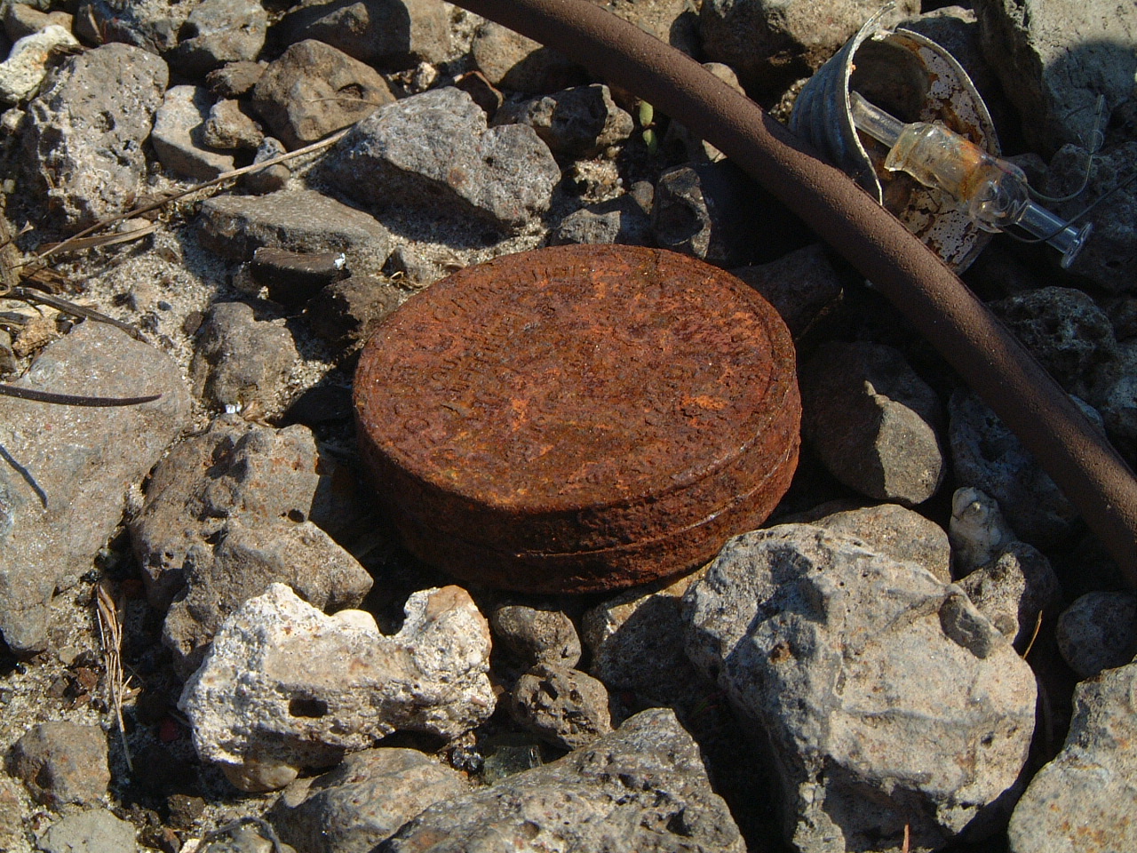maartent rusted metal tin on rocks