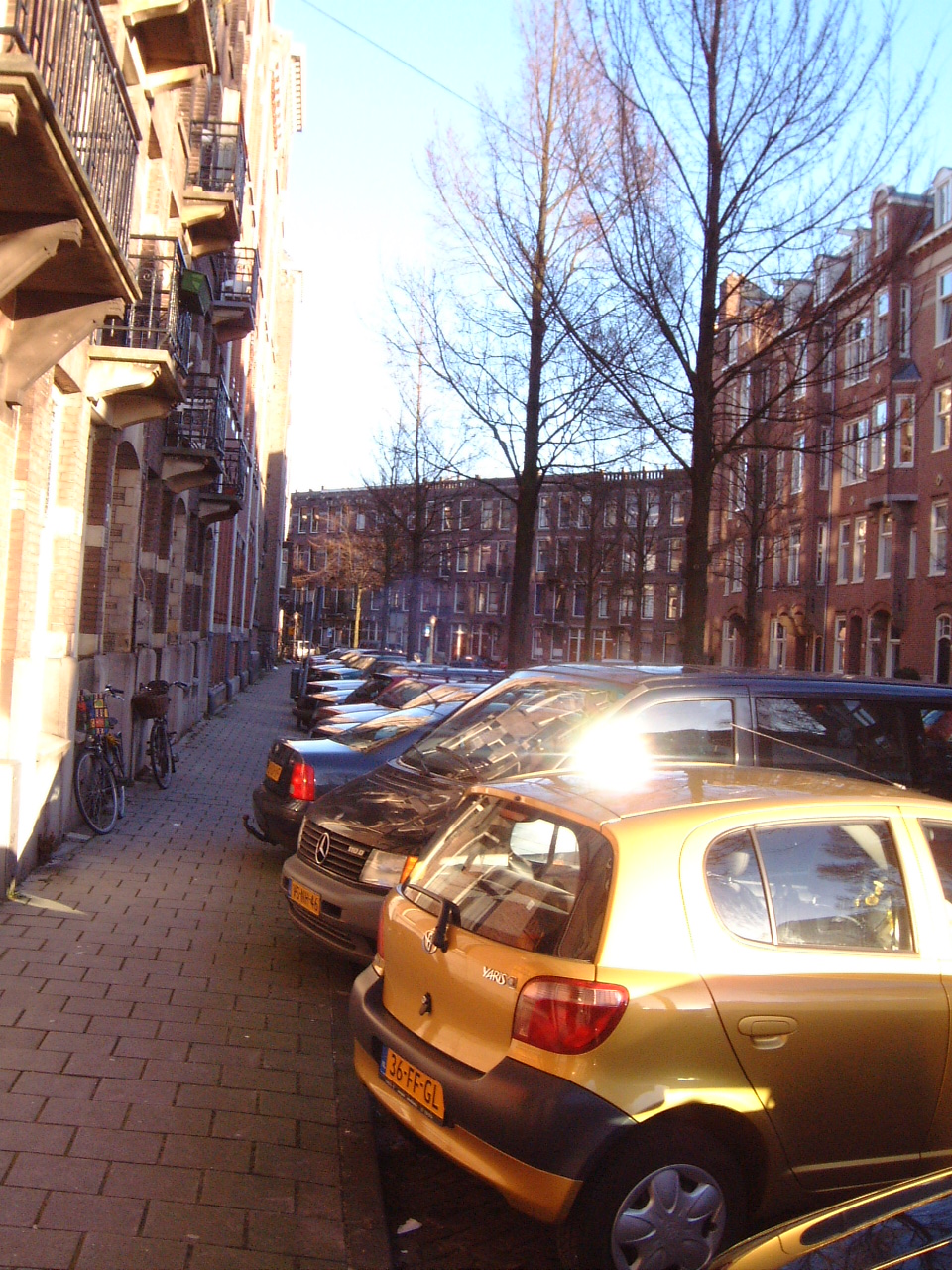 maartent street city parked cars gloss shiny houses sidewalk walkway pavement