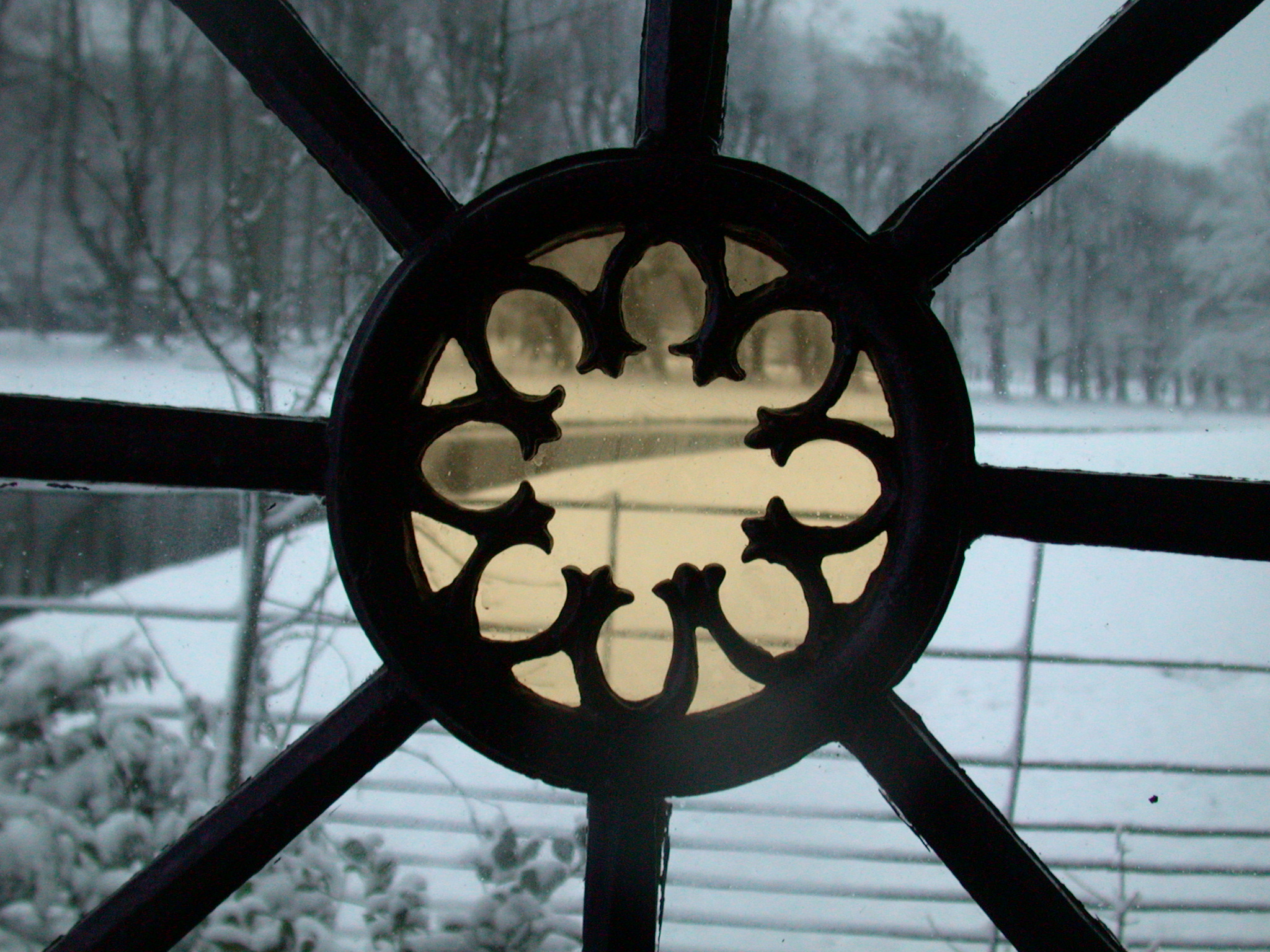 winter landscape trough a window with coulored glass center
