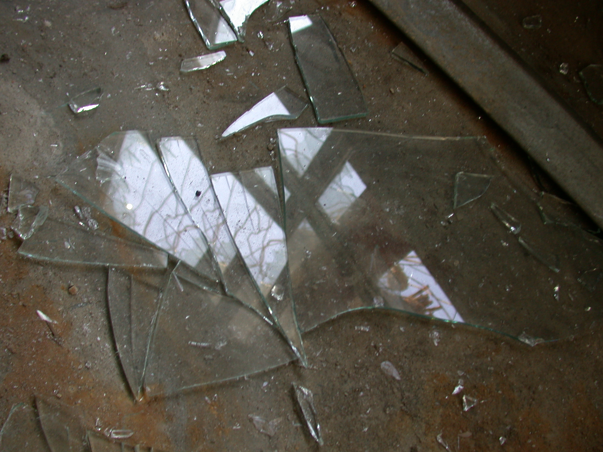 broken shards of glass on floor smashed fragments