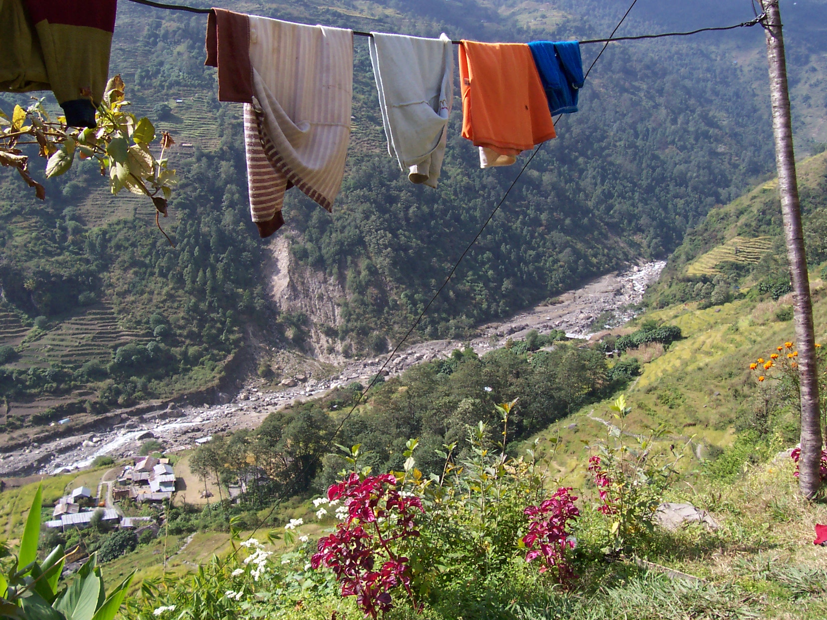 annet laundry hanging to dry with backdrop of valley with trees fields and a dry riverbed