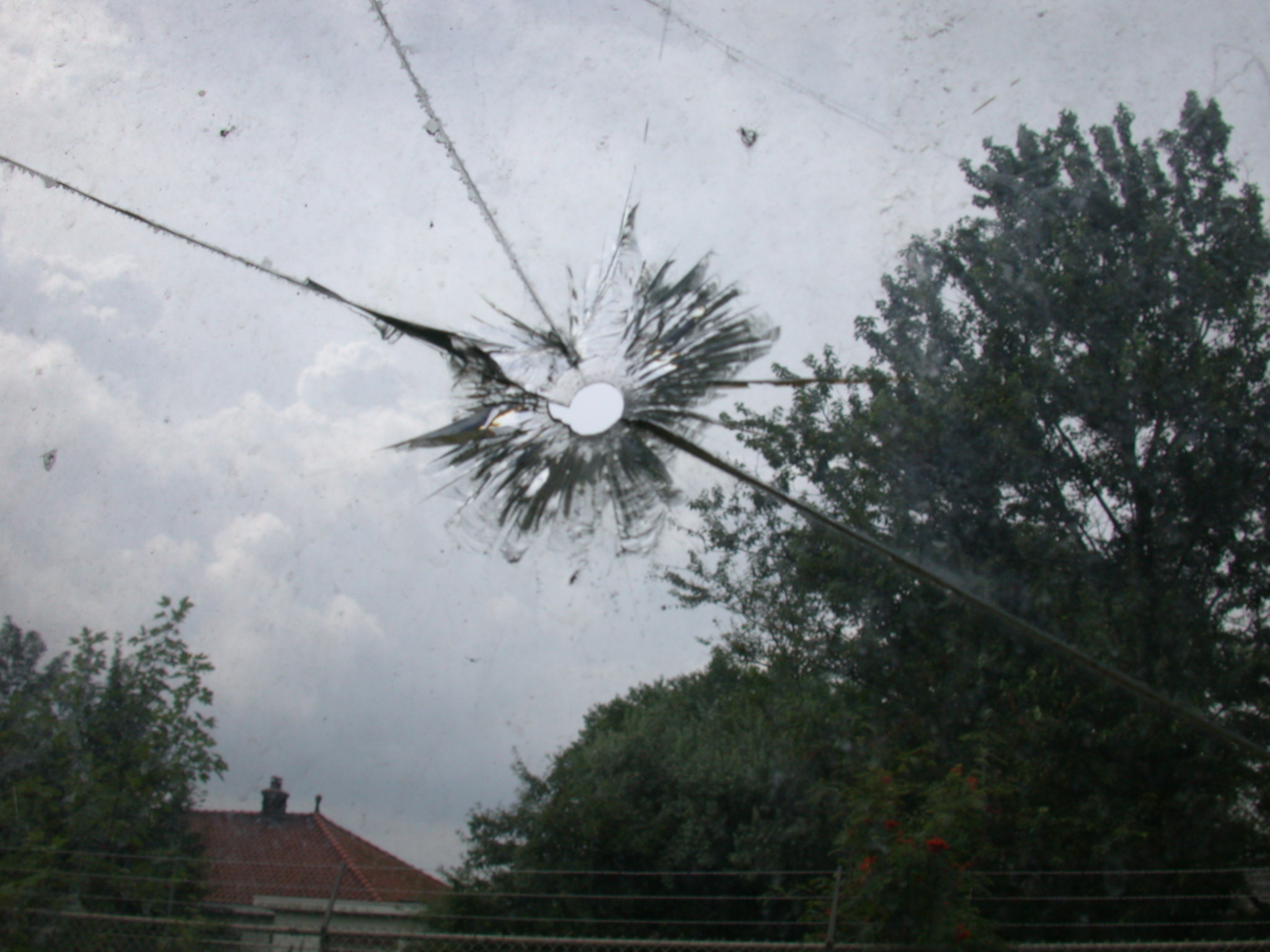 bullet hole in glass broken circle crack
