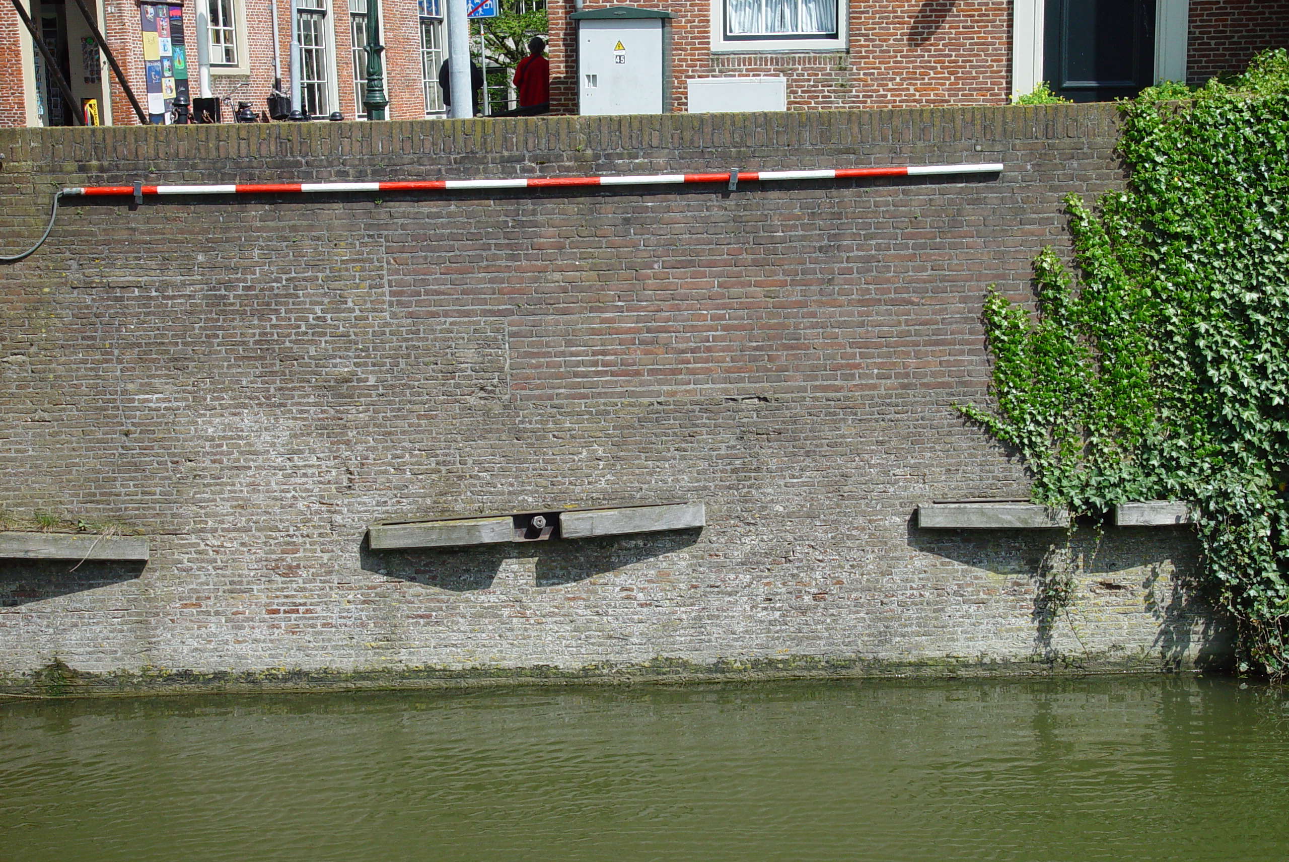 textures walls brick brickwall wood pole overgrown ivy wharf quay water canal amsterdam river