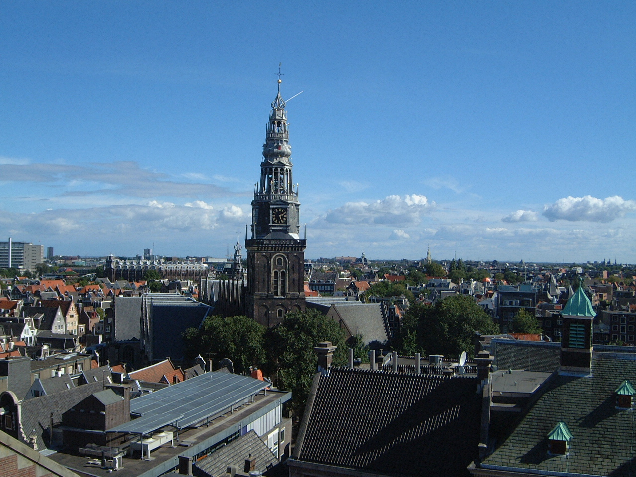 church dutch city overview roof roofs blue sky fluff clouds maartent