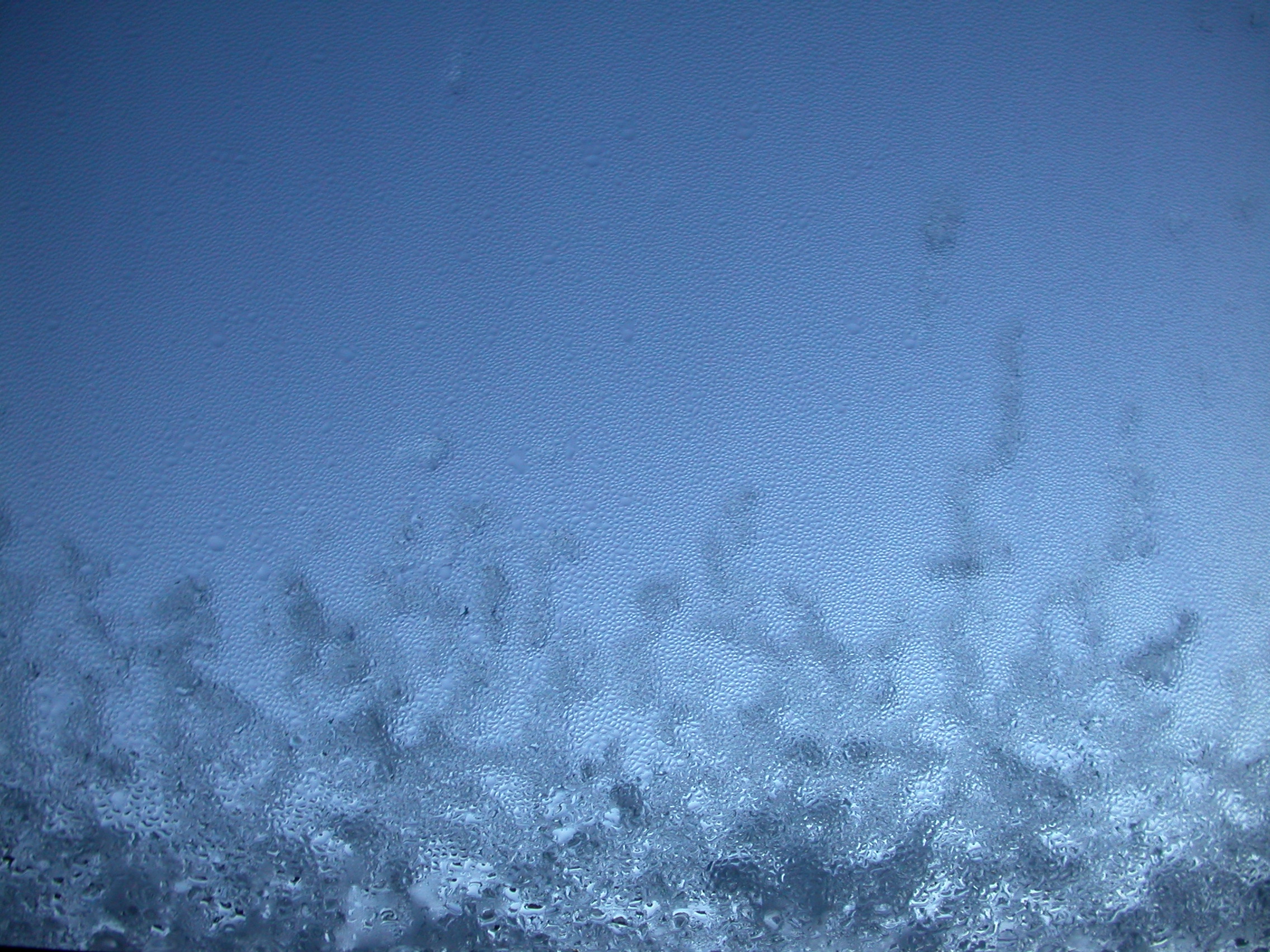 eva ice and condense on window glass blue frost winter
