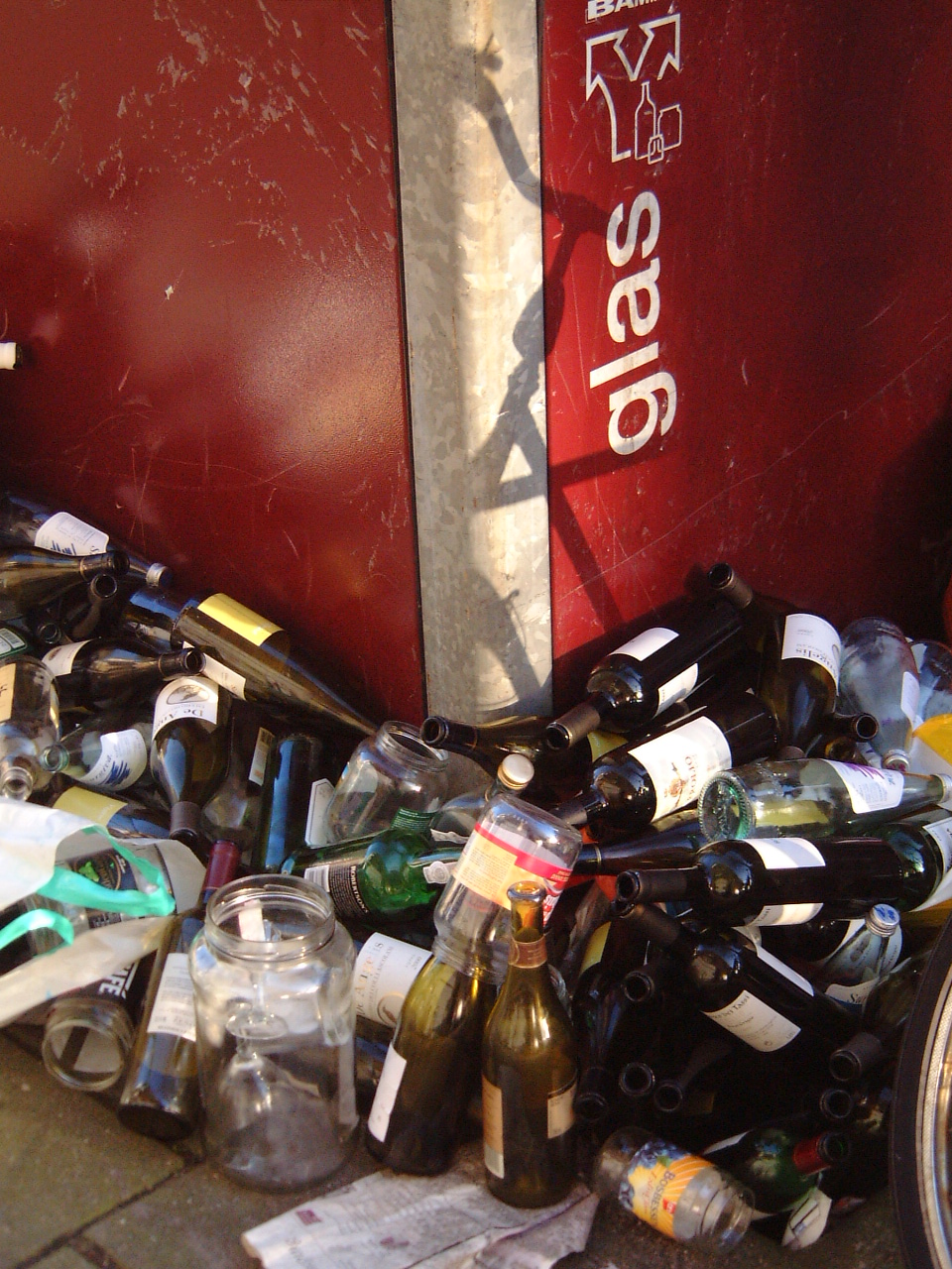 maartent bottles next to glass collection bin liquor alcohol after party