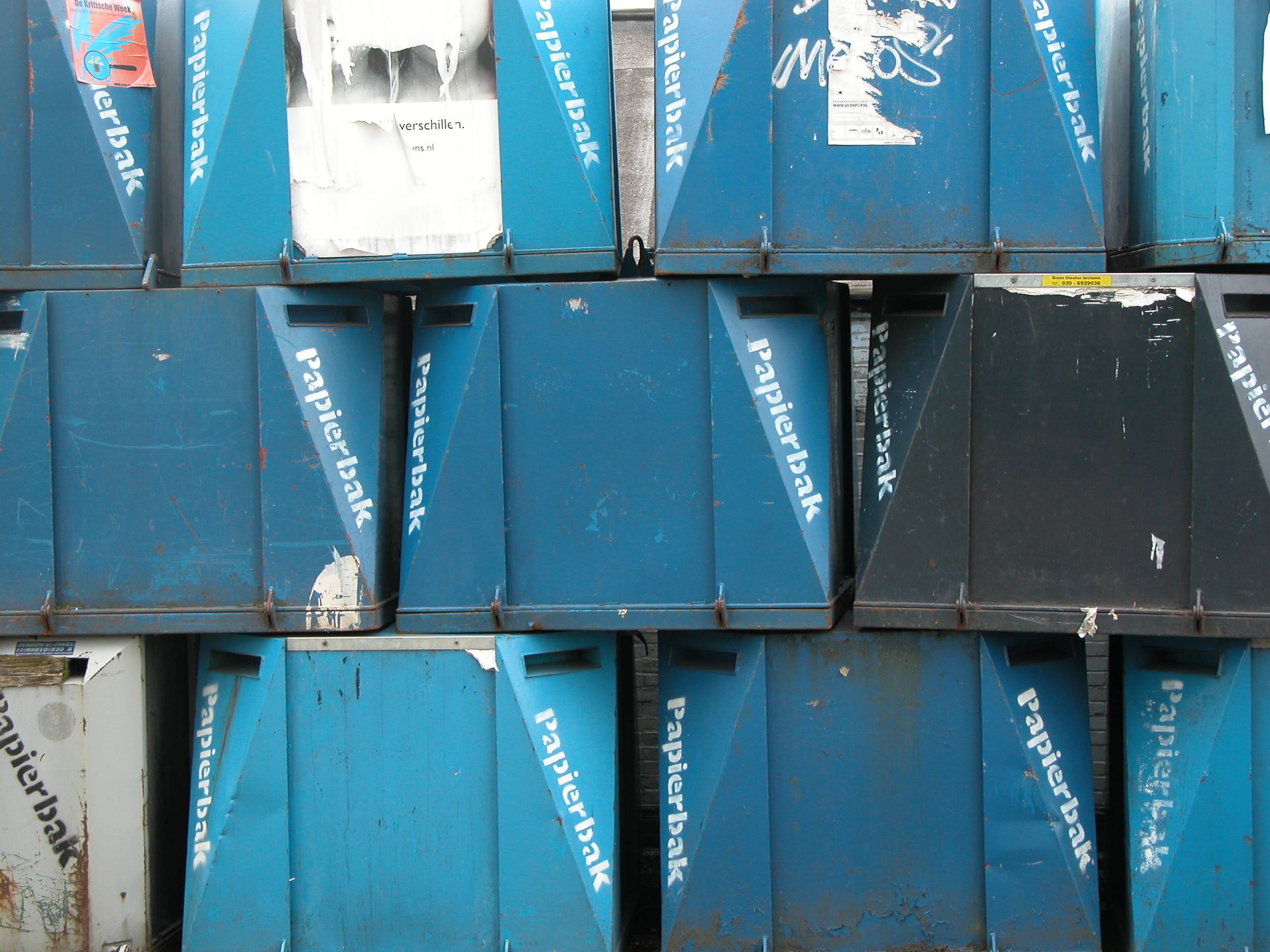 stack of metal containers for glass collection blue