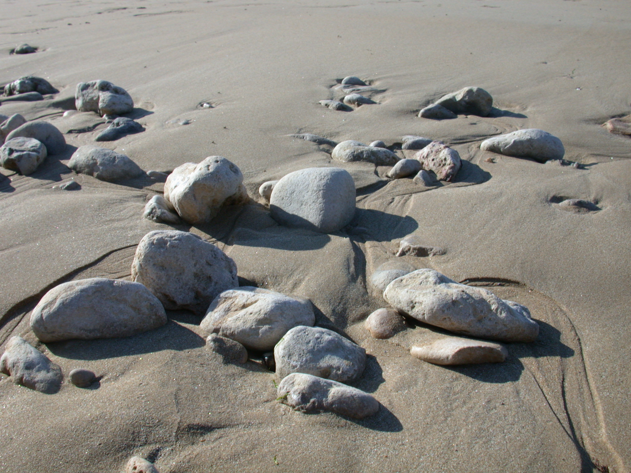 boulders rocks stones beach coast sand