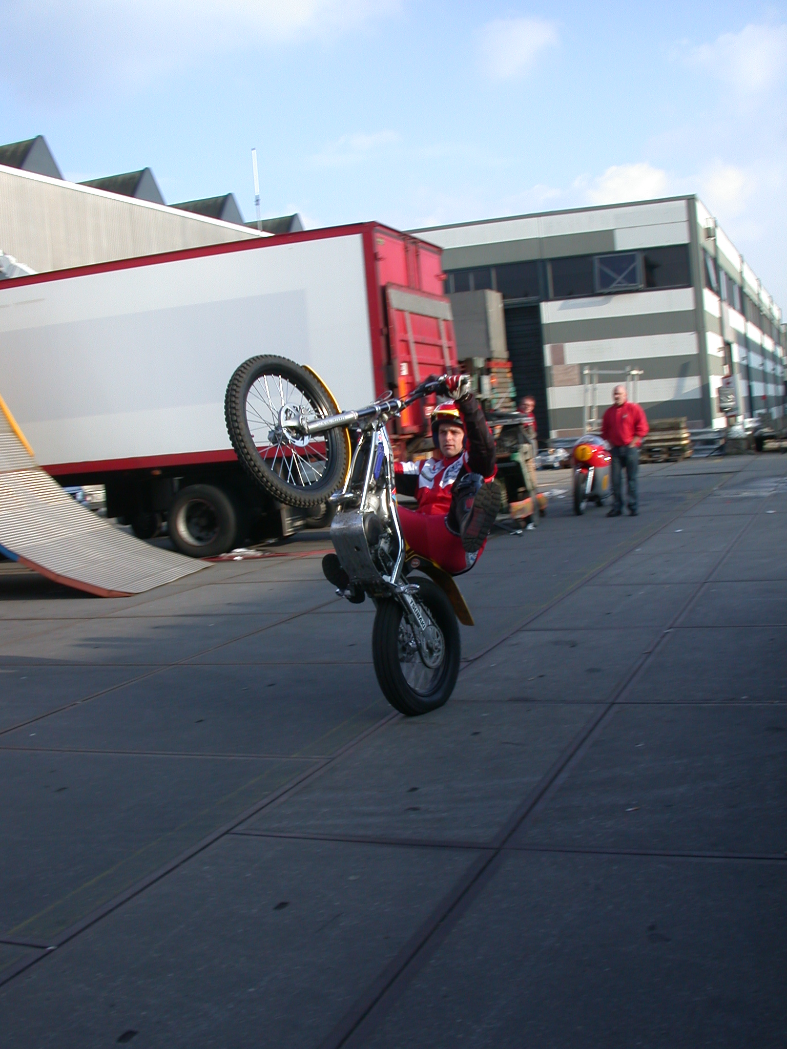 motor cycle stunt riding on one wheel