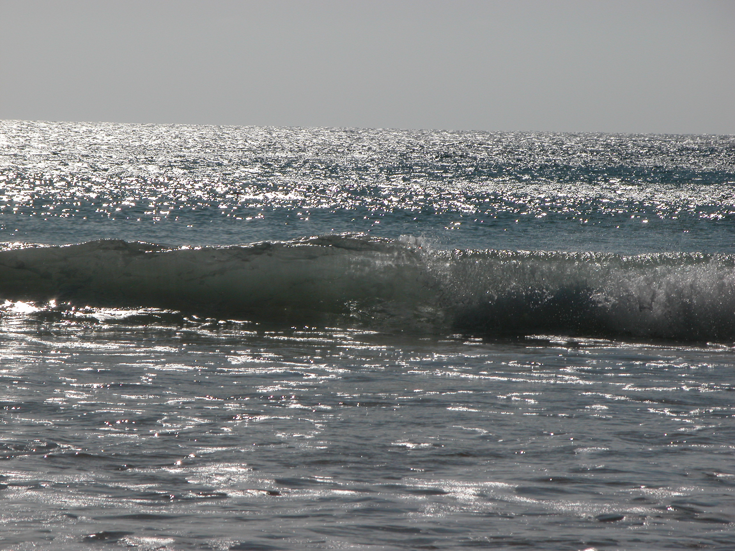 sea waves breaking wave sun glistening