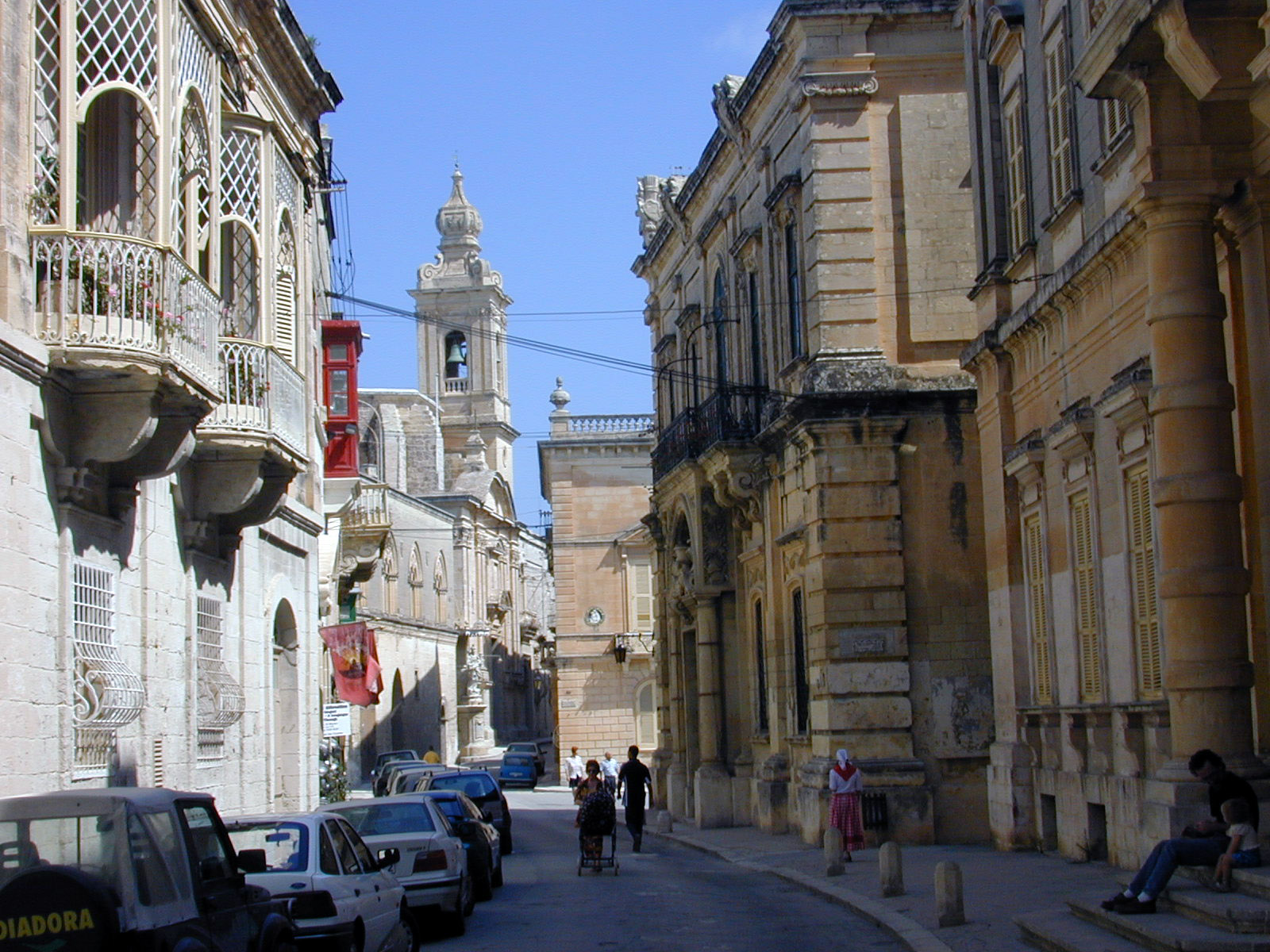 street warm mediterran buildings cars sunny city