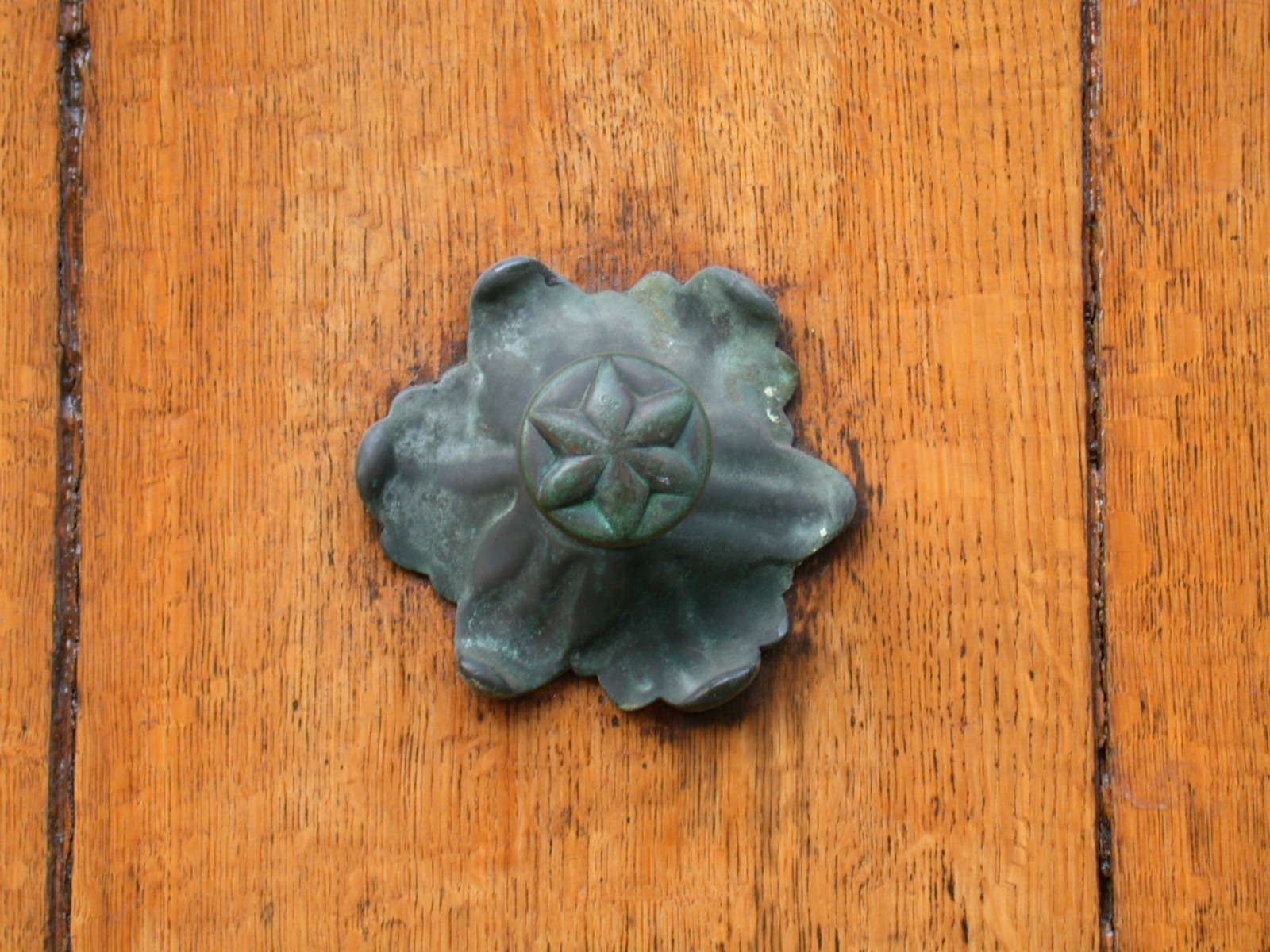 objects metal knob doorknob star tin copper teak wood texture fine painted orange royalty-free