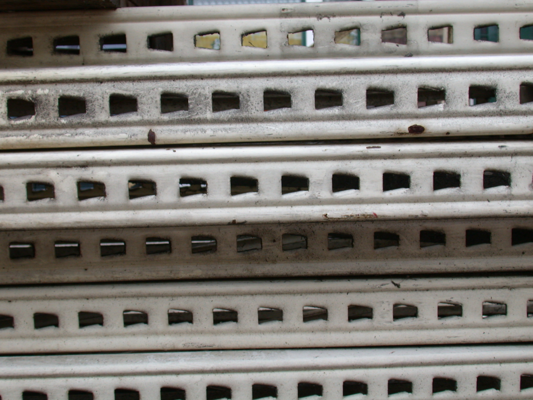 white metal beams with holes square stacked