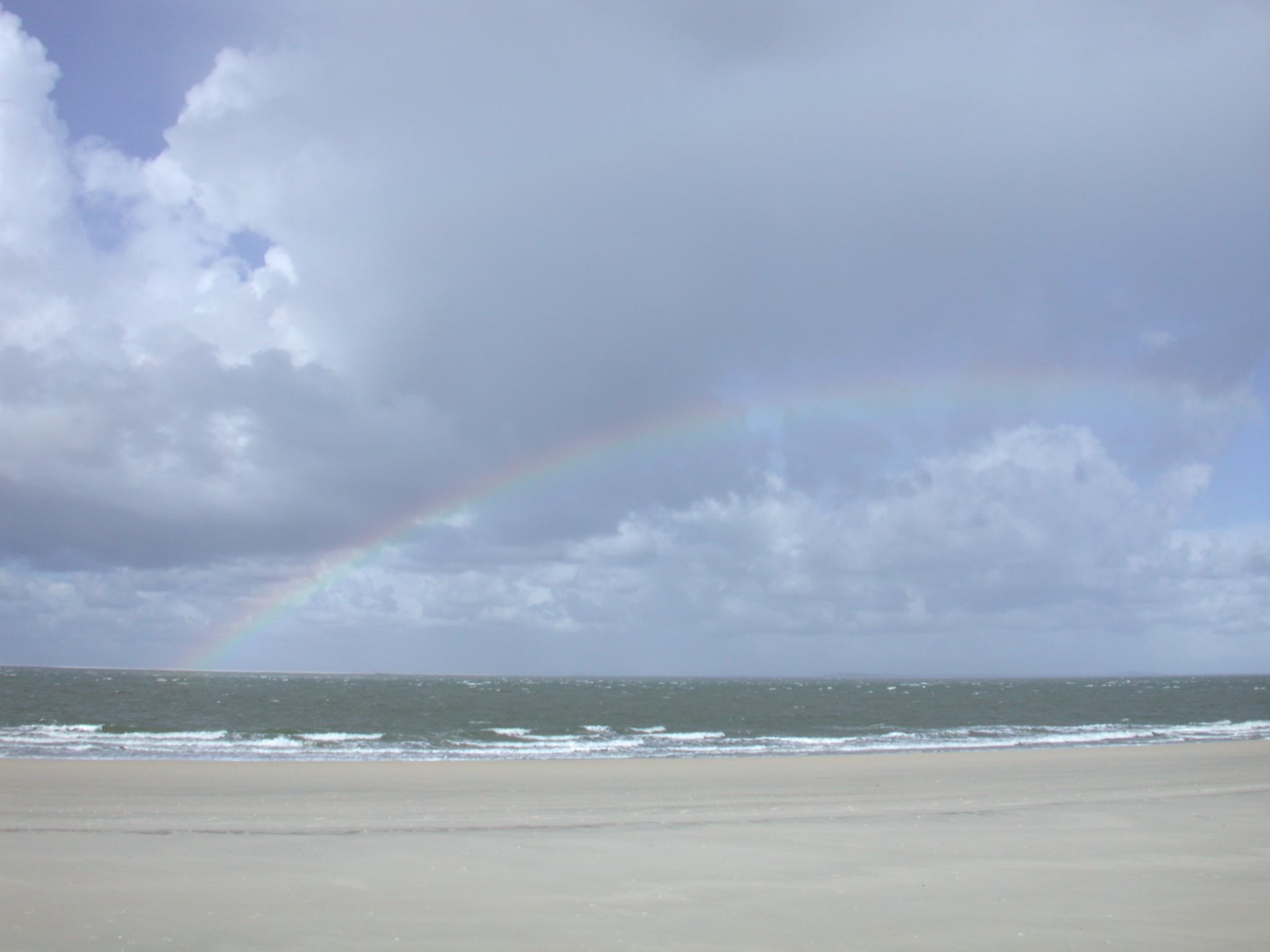 beach cold day waves breaking surf rainbow panorama horizon sea ocean