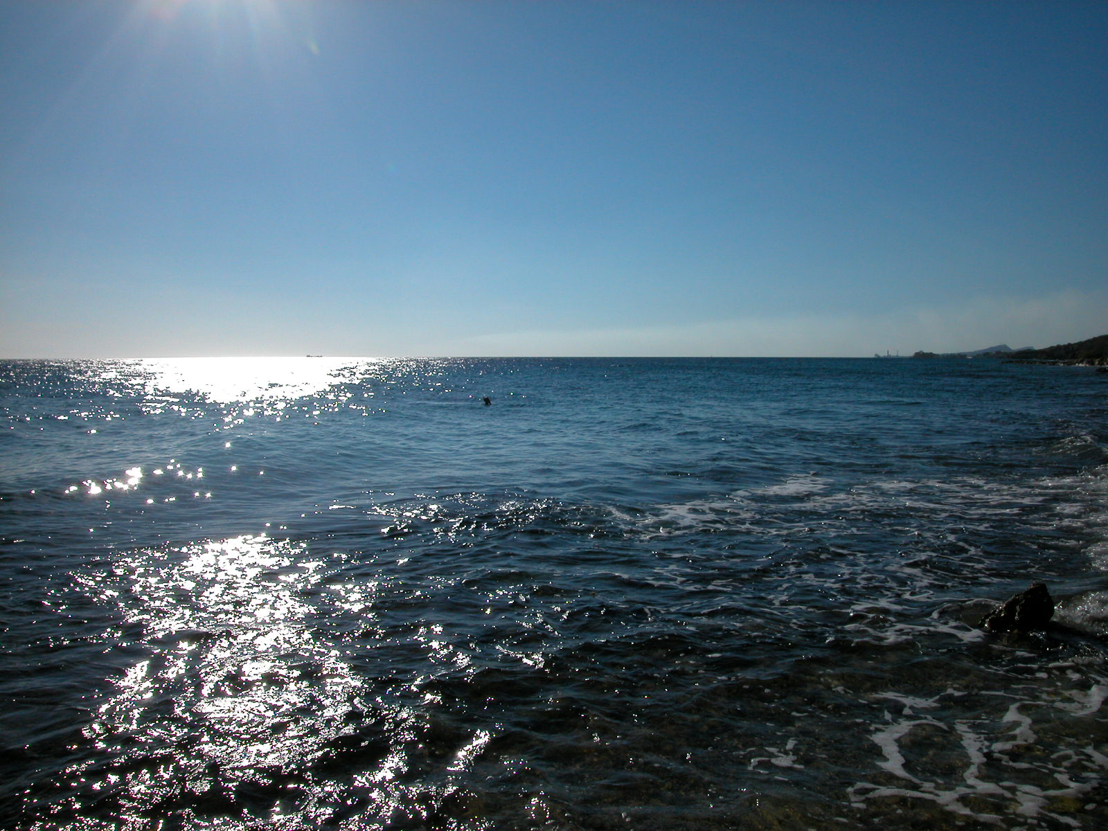 sun sea and sand blue sunshine swimmer swimming waves glistening water